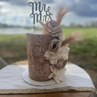 a wedding cake with the word mr and mrs on top
