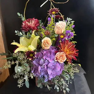 Beautiful purple hydrangea is the focal of the beautiful arrangement.