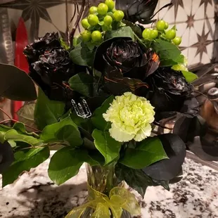 Black roses...  with green berries..