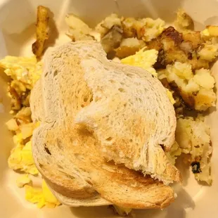 a breakfast of eggs, potatoes and toast