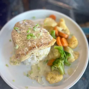 Sea bass over rice with vegetable medley. The sauce is to die for!!