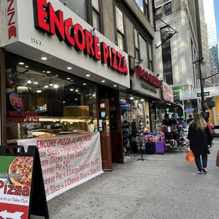the entrance to a pizza shop