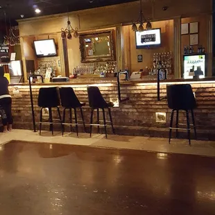 a bar with chairs