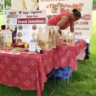 a woman setting up a table