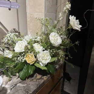 Wood and fresh flowers. Love the asymmetrical design. The flowers are gorgeous and we could not be happier with the overall design.