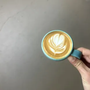 a hand holding a cup of coffee