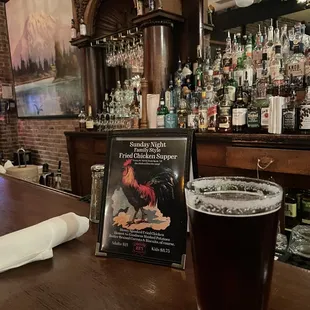 a pint of beer on a bar