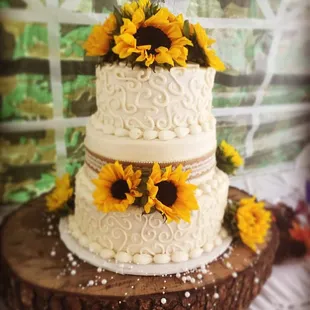 a wedding cake with sunflowers