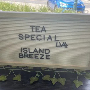 a sign that reads tea special island breeze