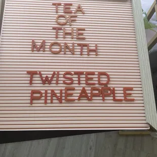 a sign that says tea for the month twisted pineapple