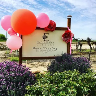 a sign with balloons