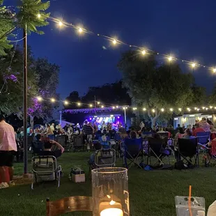 a crowd of people sitting in lawn chairs