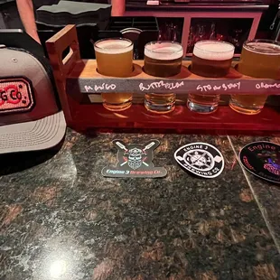 a flight of beers and a hat