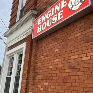 a brick building with a sign on it