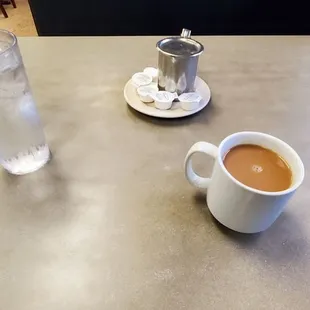 a cup of coffee and a glass of water