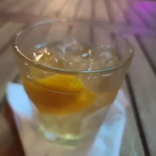 a glass of lemonade on a napkin
