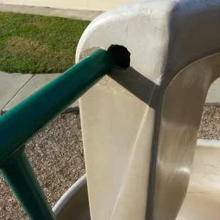 The railing next to/connected to the big spiral slide.