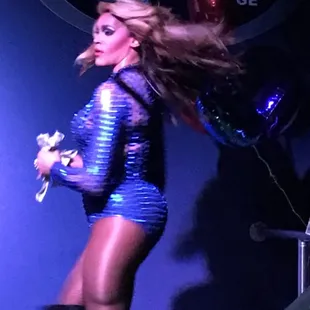 a woman in a shiny blue outfit