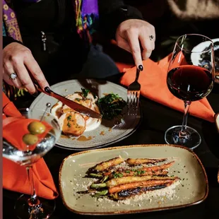 a plate of food and a glass of wine