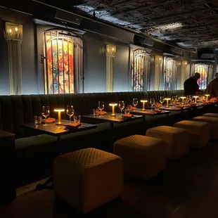 a dimly lit dining room with tables and chairs