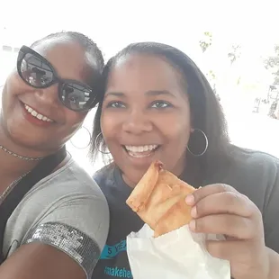 two women eating a sandwich