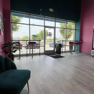 a pink room with a green chair