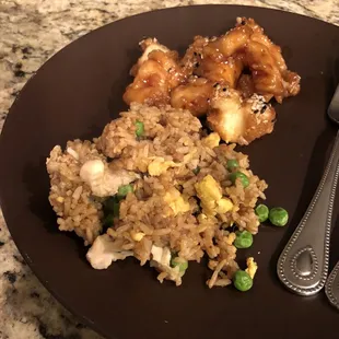 a plate of fried rice with chicken and peas