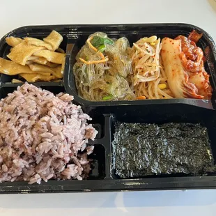 Banchan: fishcake, Japchae, kimchi, purple rice, seaweed