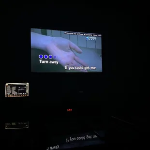 a person&apos;s hand on a tv screen