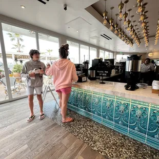 two people standing at the counter