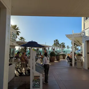 Front of the pizzeria, opposite the market.
