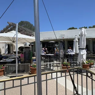 a patio with tables and umbrellas