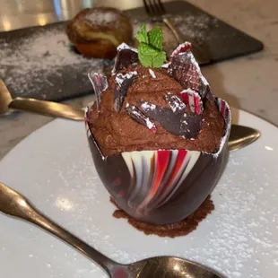 a chocolate dessert on a plate with a spoon