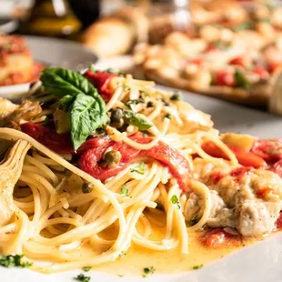 a plate of spaghetti with meat and vegetables
