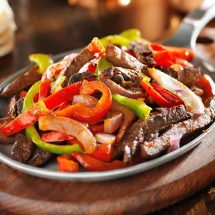 a plate of beef and peppers