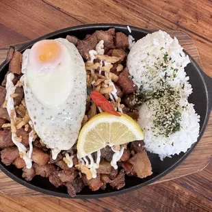 Crispy Sizzling Sisig (Crispy pork belly coated with their special sauce served on a sizzling plate with fried egg and rice) $17.95 - 3 Star