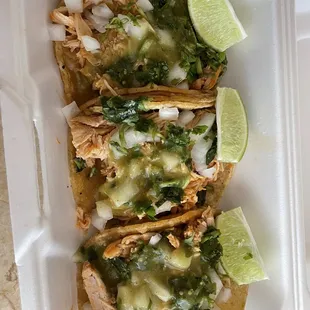 three tacos in a styrofoam container