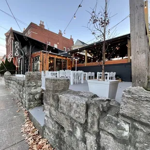 a restaurant with tables and chairs on the sidewalk
