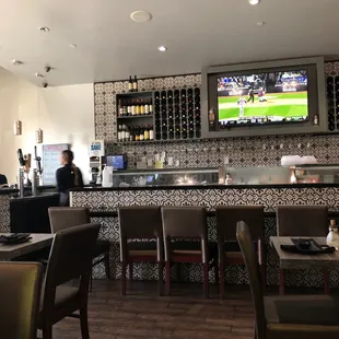 a restaurant with a bar and a television