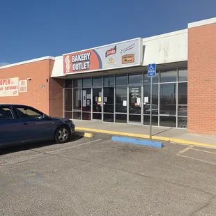 a car parked in front of a bakery outlet
