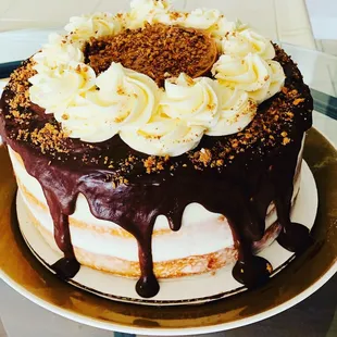 Naked Butter Cake w/Vanilla Cream, Chocolate Ganache, Chocolate Cream Filling, Sprinkles of Toffee.
