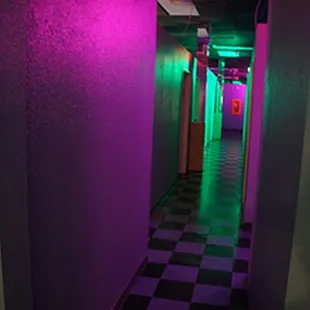 a long hallway with neon lights