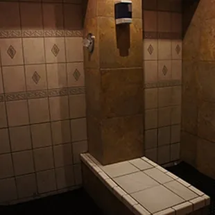 a bathroom with tiled walls and floor