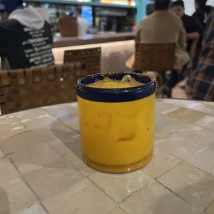 a glass of orange juice on a table