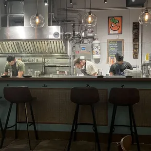 a restaurant kitchen with people preparing food