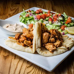 Mediterranean style chicken, served with pita &amp; tahini yogurt sauce, lettuce, cucumber, tomato, red onion