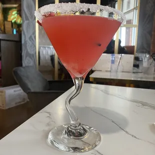 a cocktail in a martini glass on a table