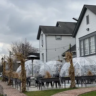 a row of tables and chairs outside a restaurant