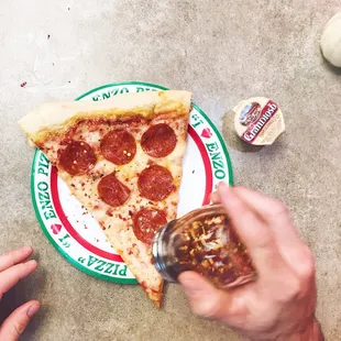 Pepperoni pizza and some garlic sauce.