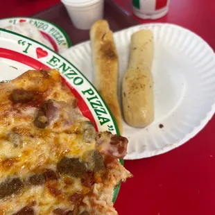 a slice of pizza on a paper plate